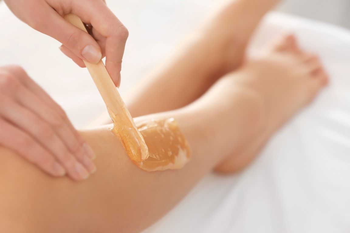 a lady getting her legs waxed