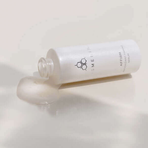 A bottle of Affirm serum on it's side with product coming out. It is a supercharged Antioxidant Firming Serum