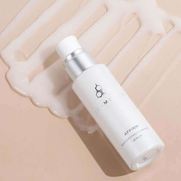 A bottle of Affirm serum, laying in product.