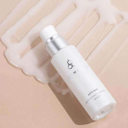 A bottle of Affirm serum, laying in product.