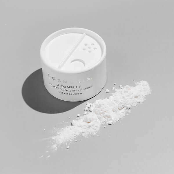 A jar of B Complex vitamin boosting powder, a nutrient-rich Vitamin B Boosting Powder that instantly enhances the results of your favorite serum and moisturizer! 