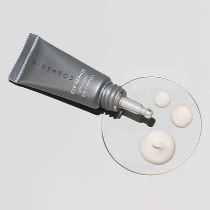 Eye Genius tube laying flat with product around it. This luxe, lightweight Brilliant Eye Complex delivers much-needed hydration as it targets three stubborn eye area issues—dark circles, under eye bags and crow’s feet. 