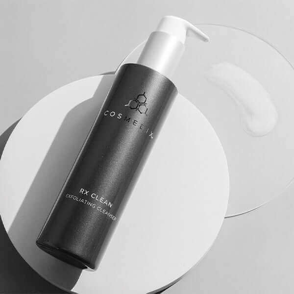 RX Clean bottle on it's side. It is an Exfoliating Cleanser with 10% L-Lactic Acid that removes oil, dirt and daily impurities for softer, even-looking skin tone and texture after a single use.