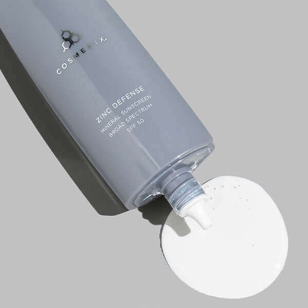  Zinc Defense bottle on it's side poured out some Mineral Sunscreen Broad Spectrum SPF 50