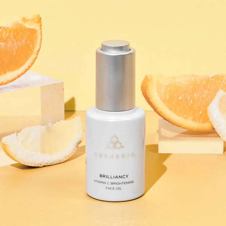 Brilliancy vitamin C brightening face oil bottle with slices of oranges