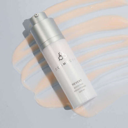 a bottle on it's side of Revert it  is a Boosting Brightening Serum that helps to reduce the appearance of age spots and skin blotches